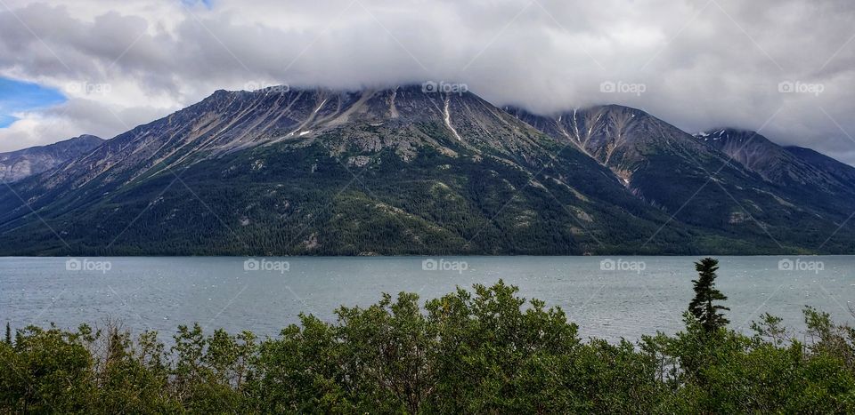 Clouds creeping down the mountain side