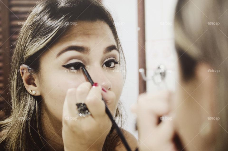 Woman putting makeup on 