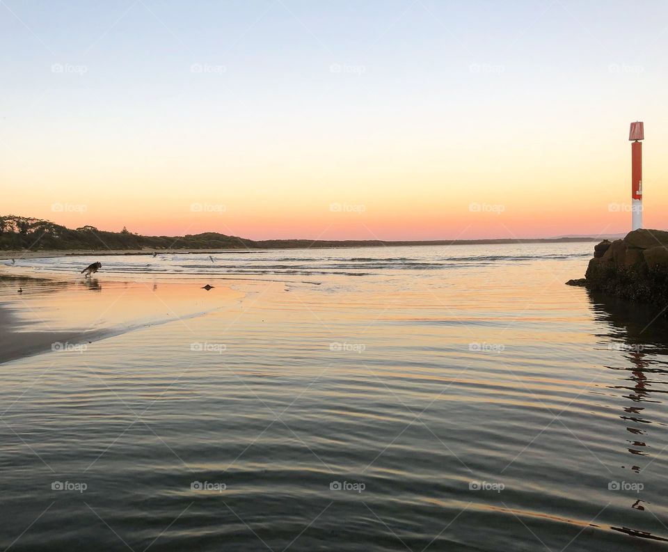 Reflections and ripples on the beach at sunset 