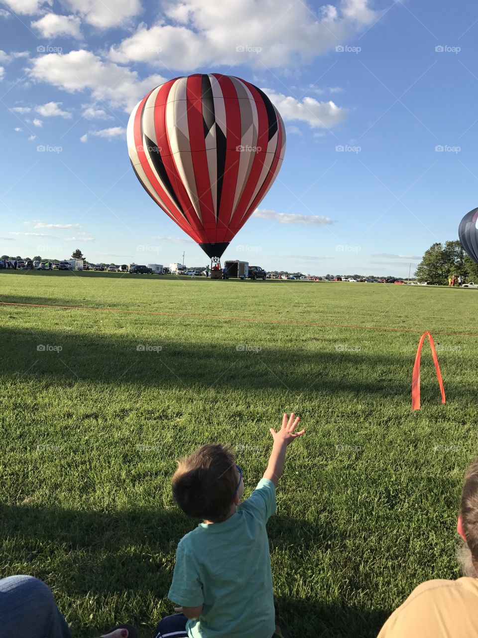 Child reaching for hot air balloon 