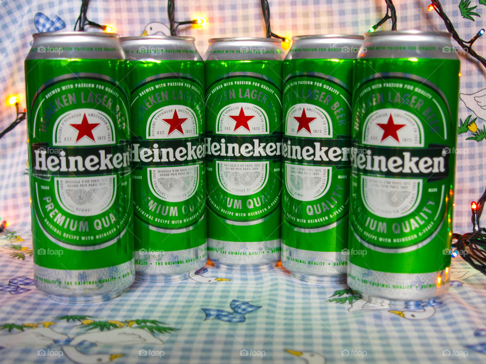 Heineken on checkered tablecloth with color light garlands.