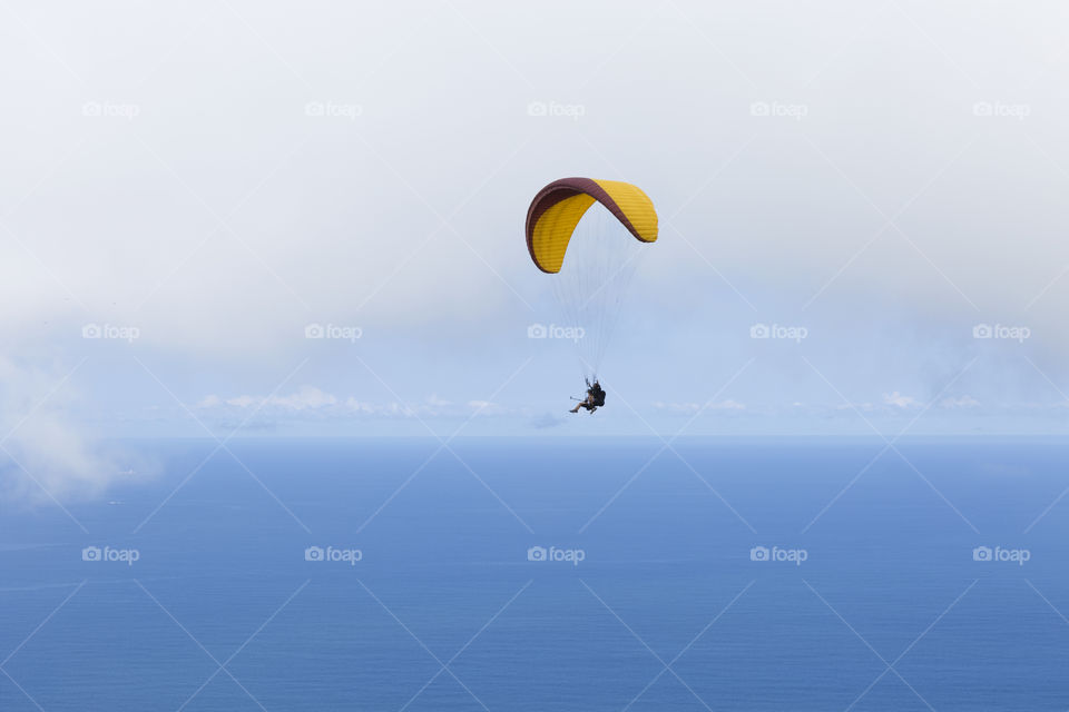 Paraglider flying over Sao Conrrado in Rio de Janeiro Brazil.