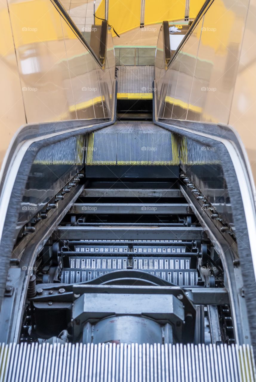 A view inside an escalator which is under repair and partially dismantled 