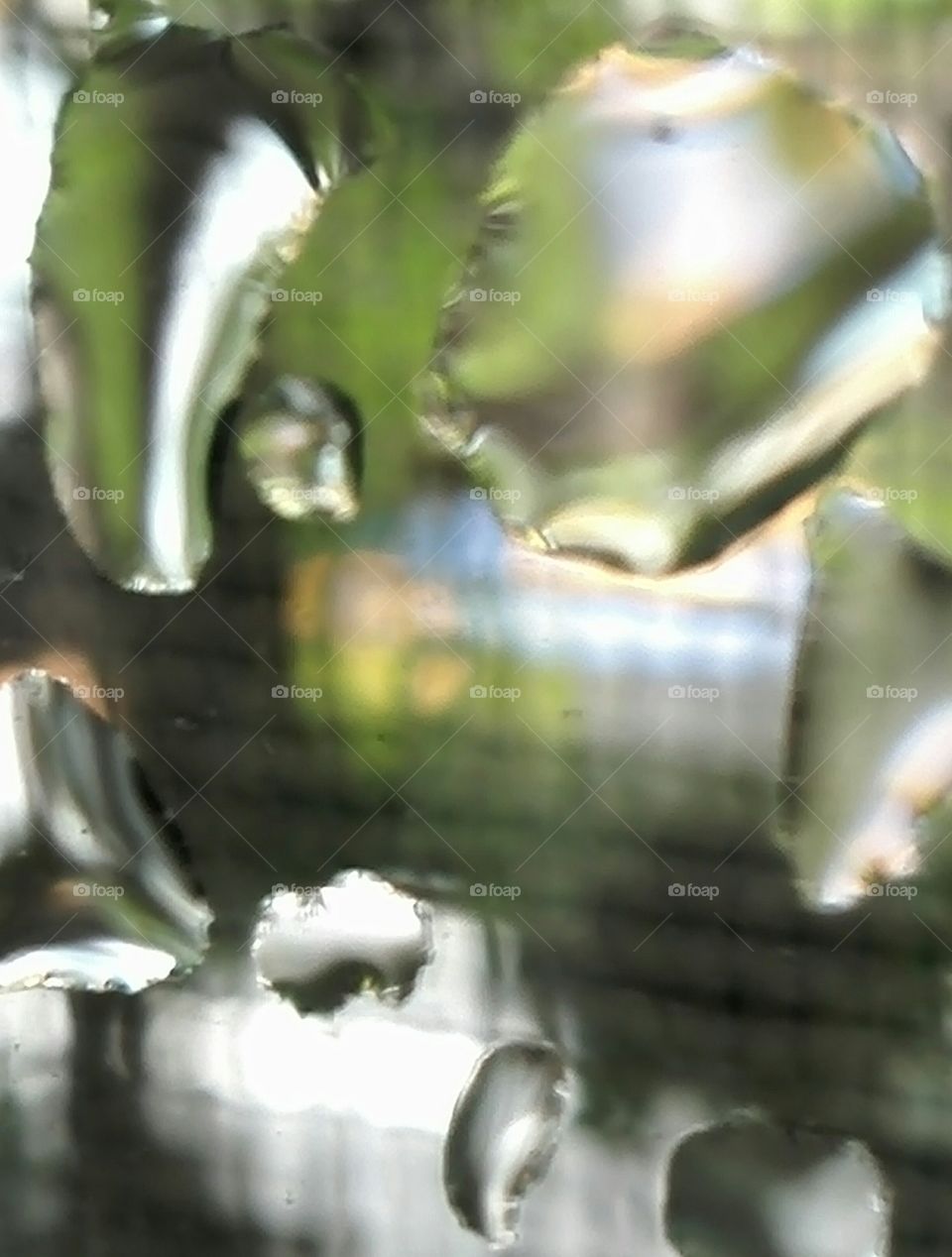 Waterdrops on window glass. Interplays of water, double-glass window, and focusing system may produced some distortion.