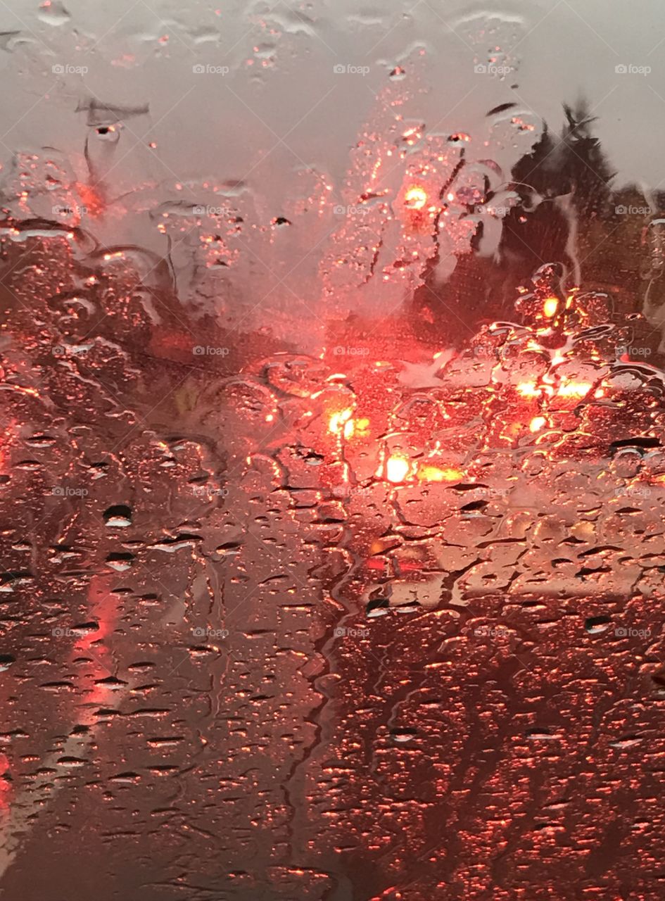 Car stopped at a red light in the rain