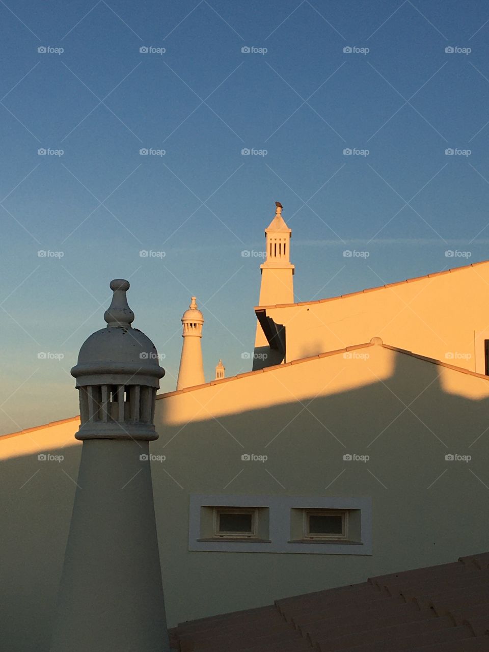 Sunrise on roof and chimneys 