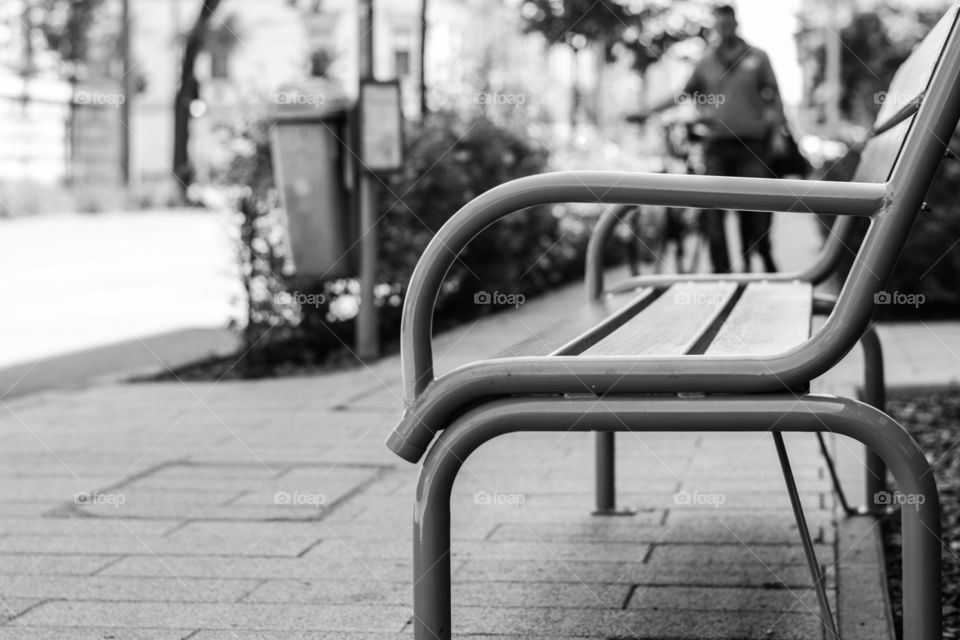 Iron bench in city park. Black and white photo. Photographed in Szeged, Hungary