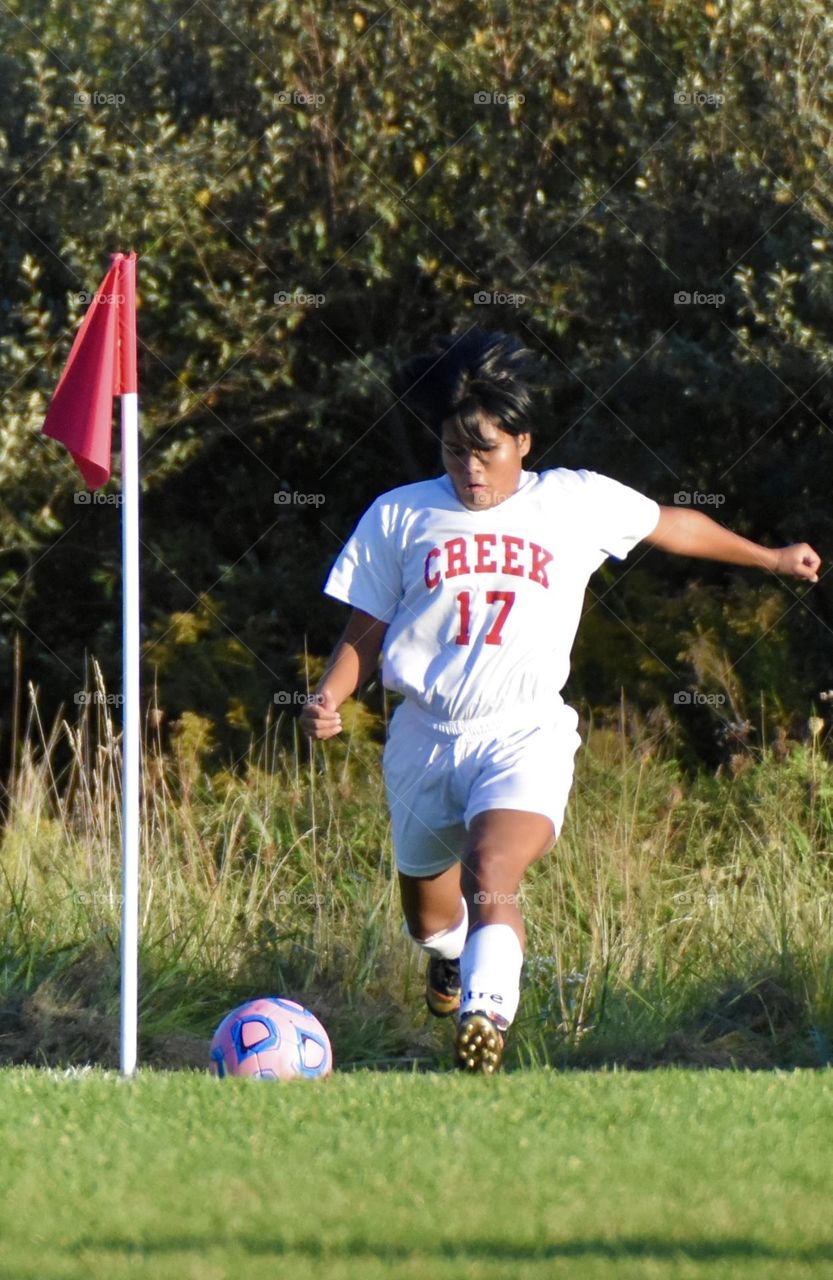 Soccer player getting ready to kick the ball