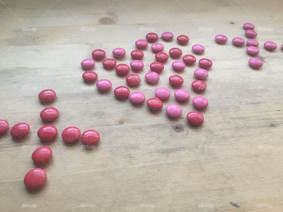 Valentine's Day pink and red valentines candies that say I love you and XoX