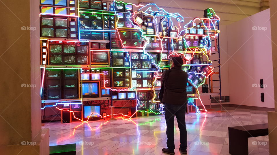 America on-line. A viewer looks at an art exhibit.