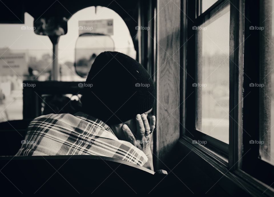 Person sitting near bus window