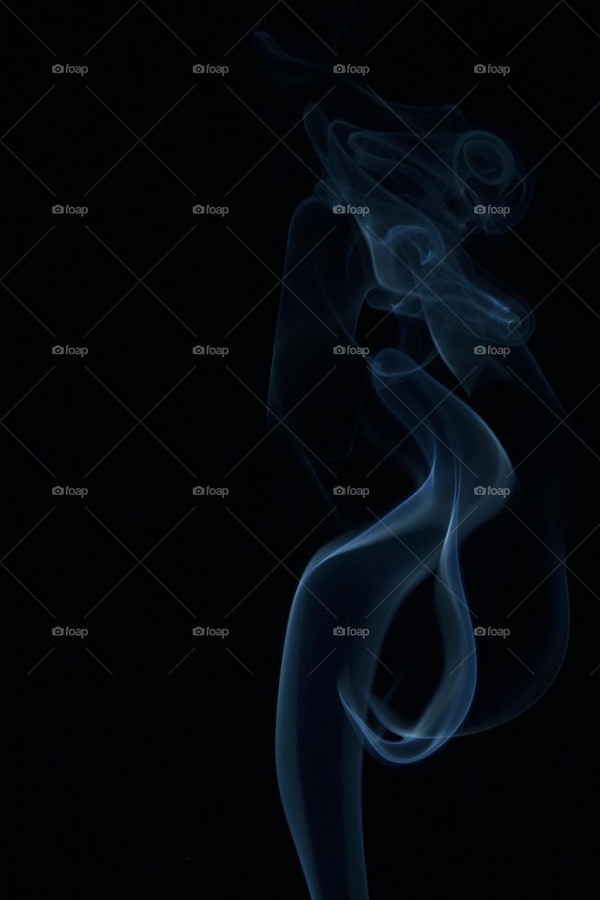 Abstract blue smoke on black background