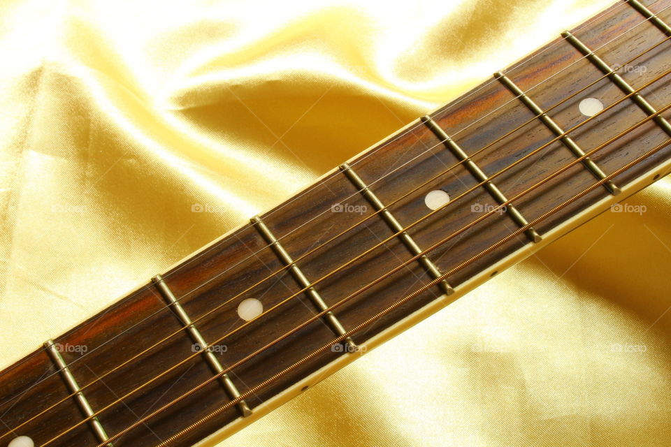 acoustic guitar on Golden textile