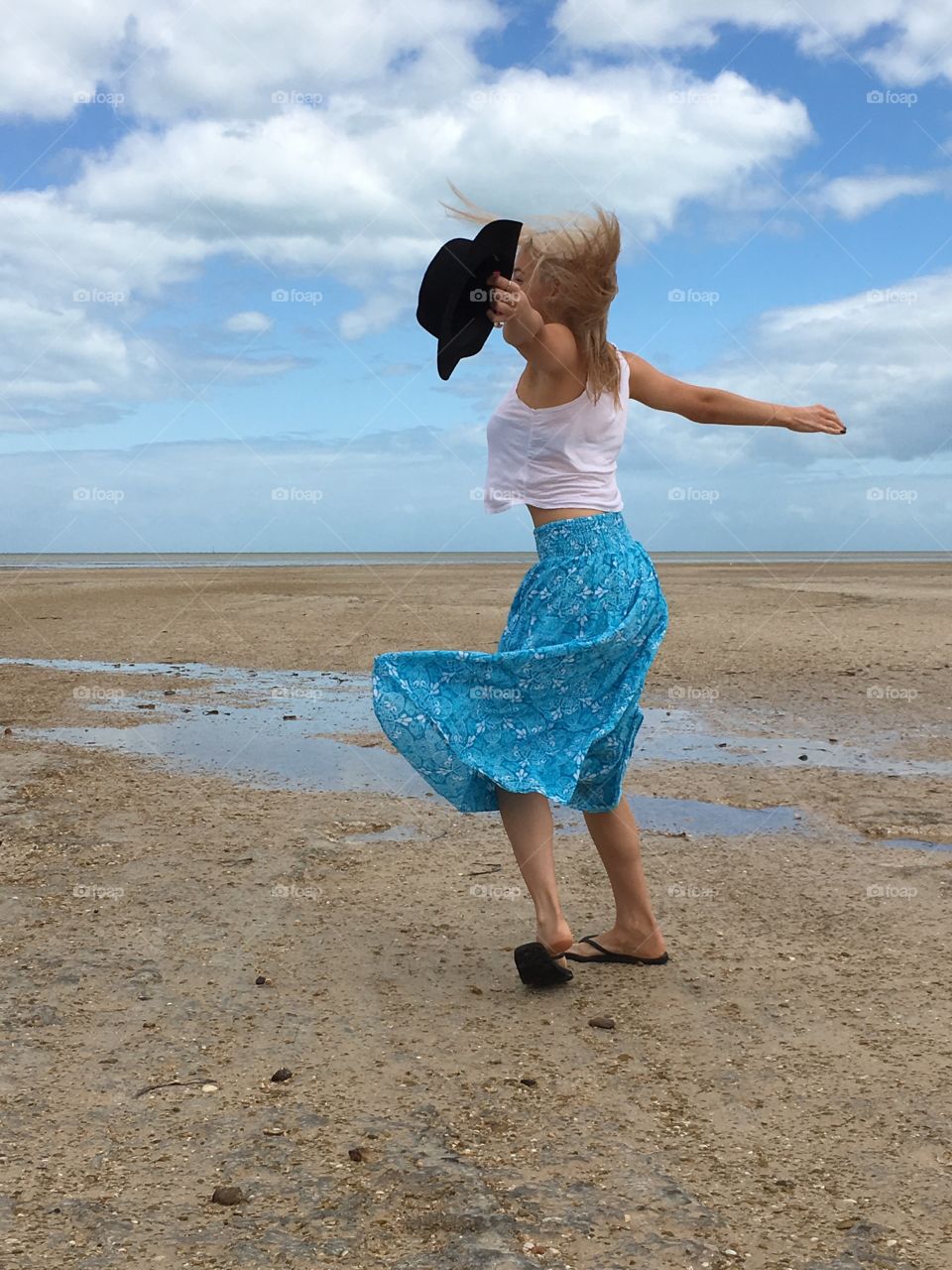 A woman dancing on beach, artistic expression free form