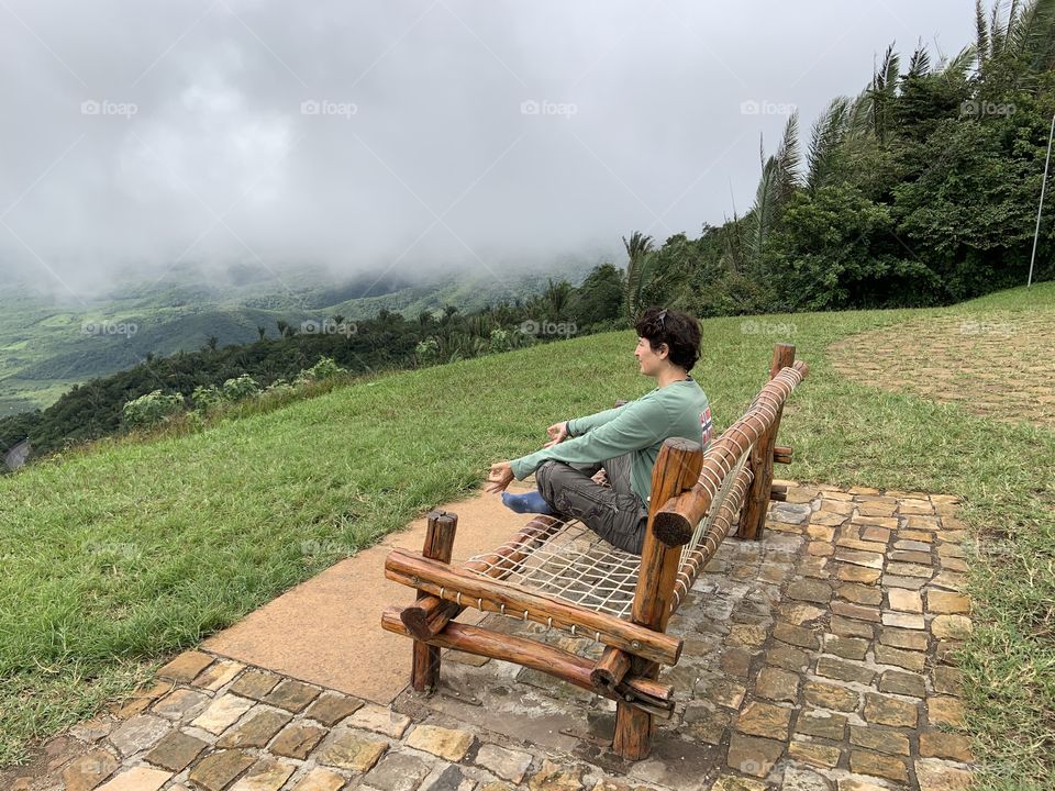 Yoga looking at valley with fog 