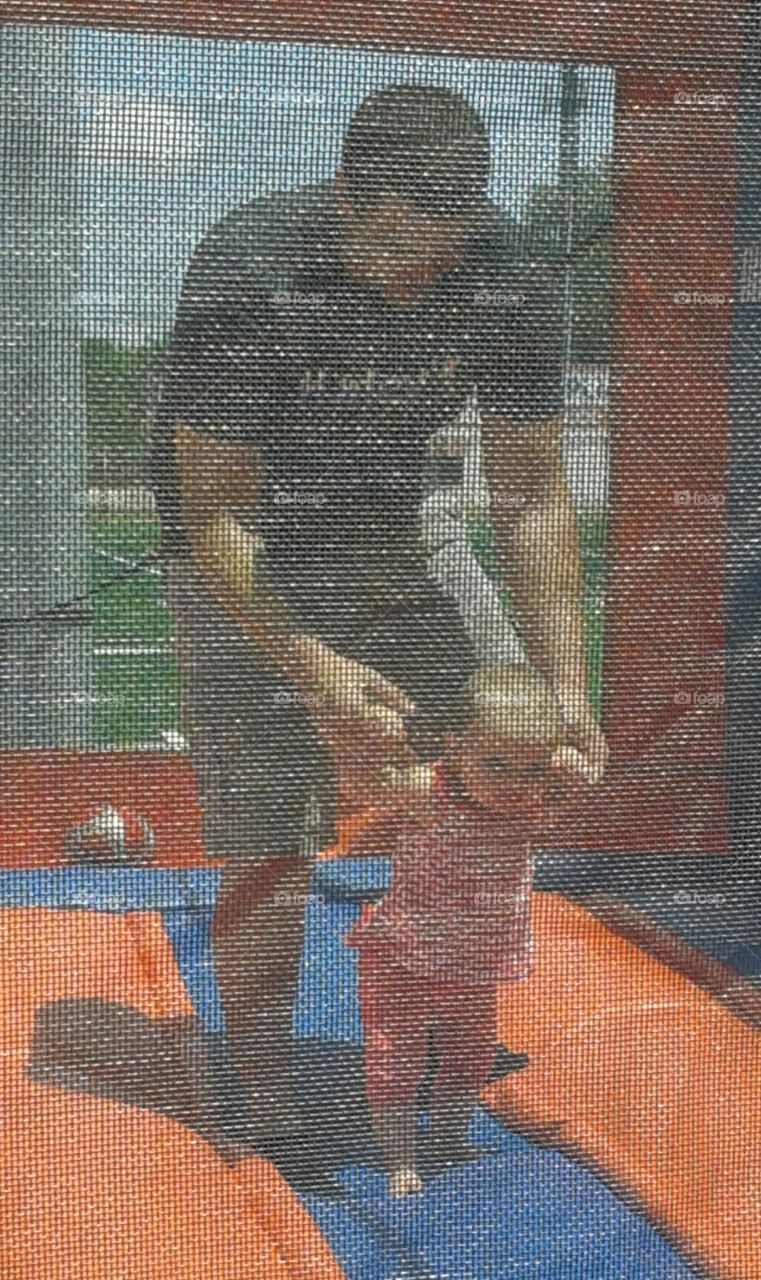 On Shaky Ground. little girl learning with Daddy about bouncy houses.
