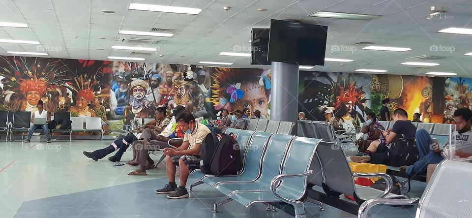 Jacksons Airport - Port Moresby Papua New Guinea. Artwork on walls showing our traditional wear by local artists.