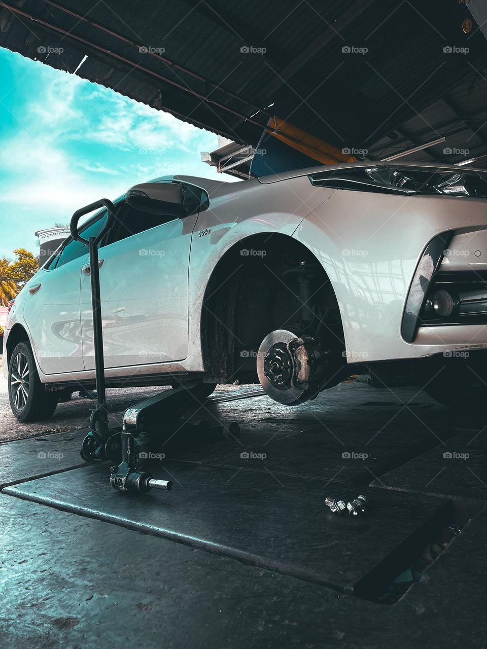 Repairing car in progress. Close up view car with no tyre