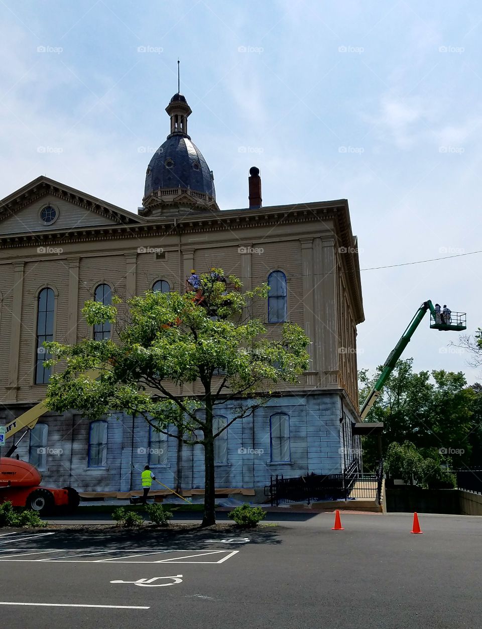 Back of a Town Hall being refurbished to original colors of browns, not white as usually sees.