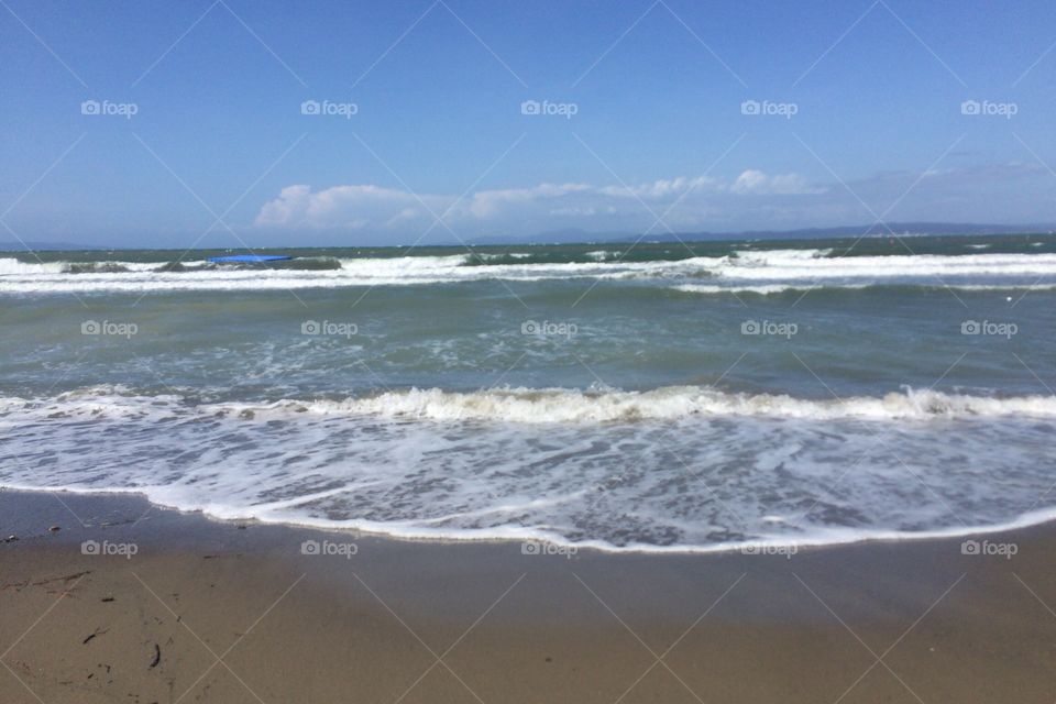 Wave on the beach in Tuscany Italy 