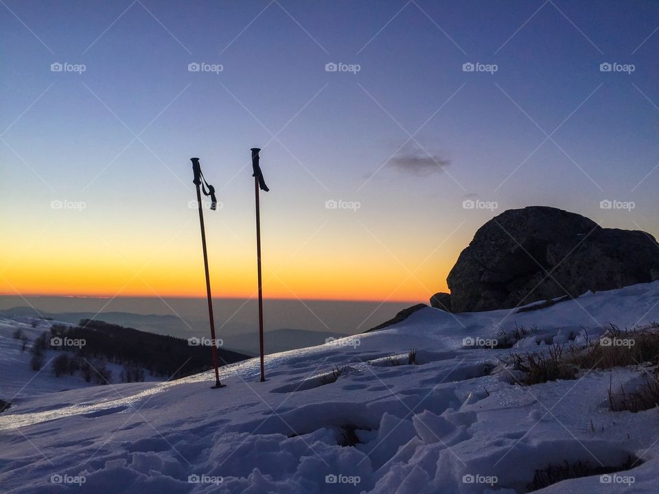 Ski poles and sunset