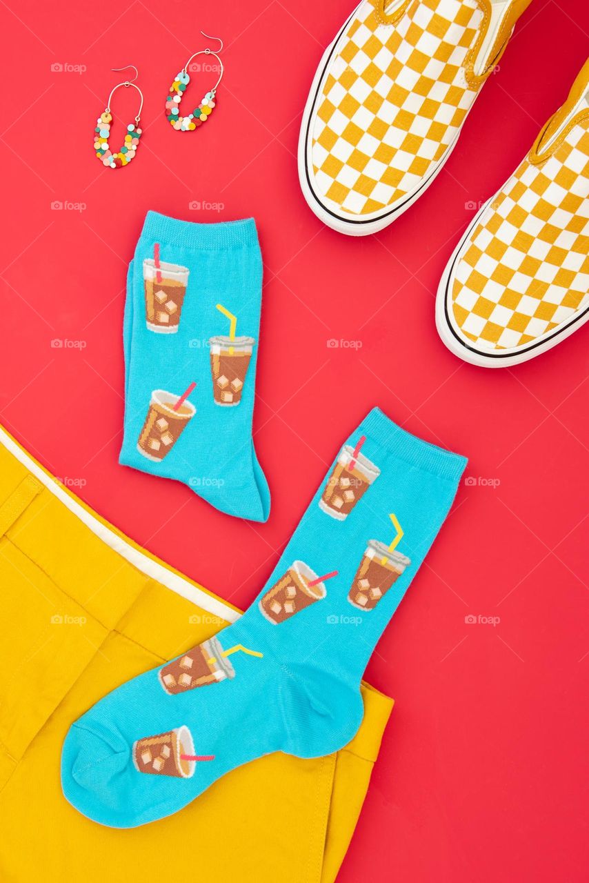 Colorful flat lay product shot of a pair of socks with accessories 