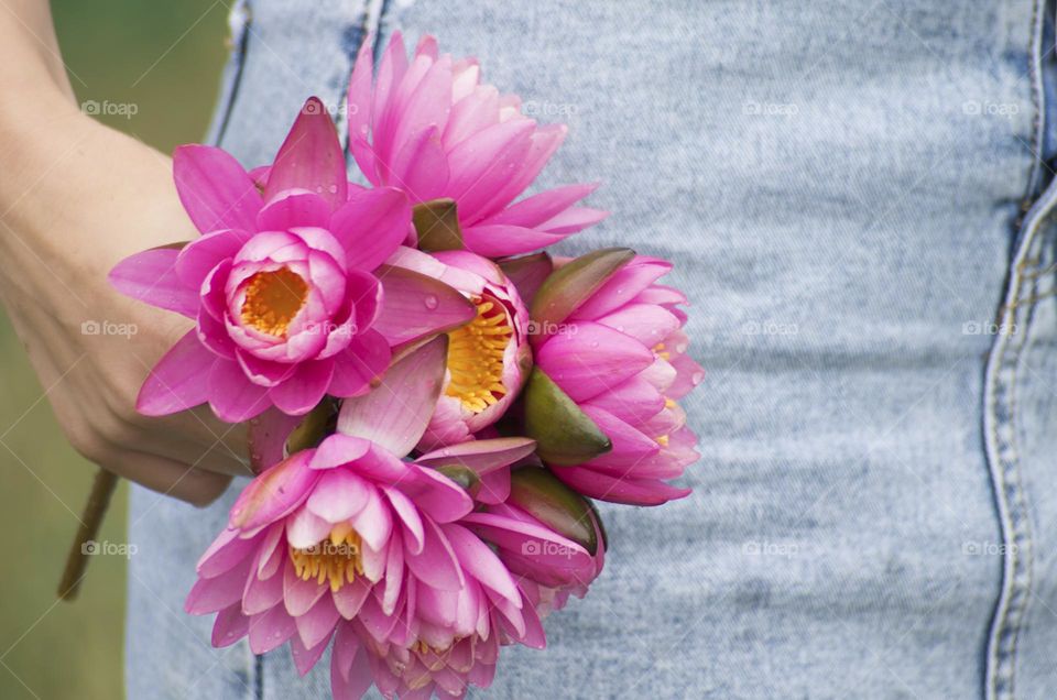 a bouquet of lilies in the hands of a girl