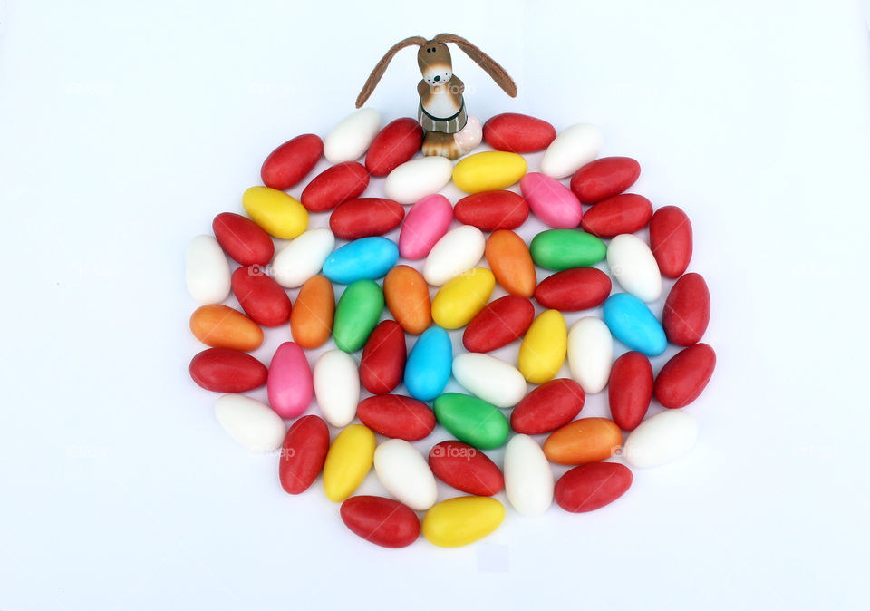 Happy Easter! Bunny with colored sugar eggs