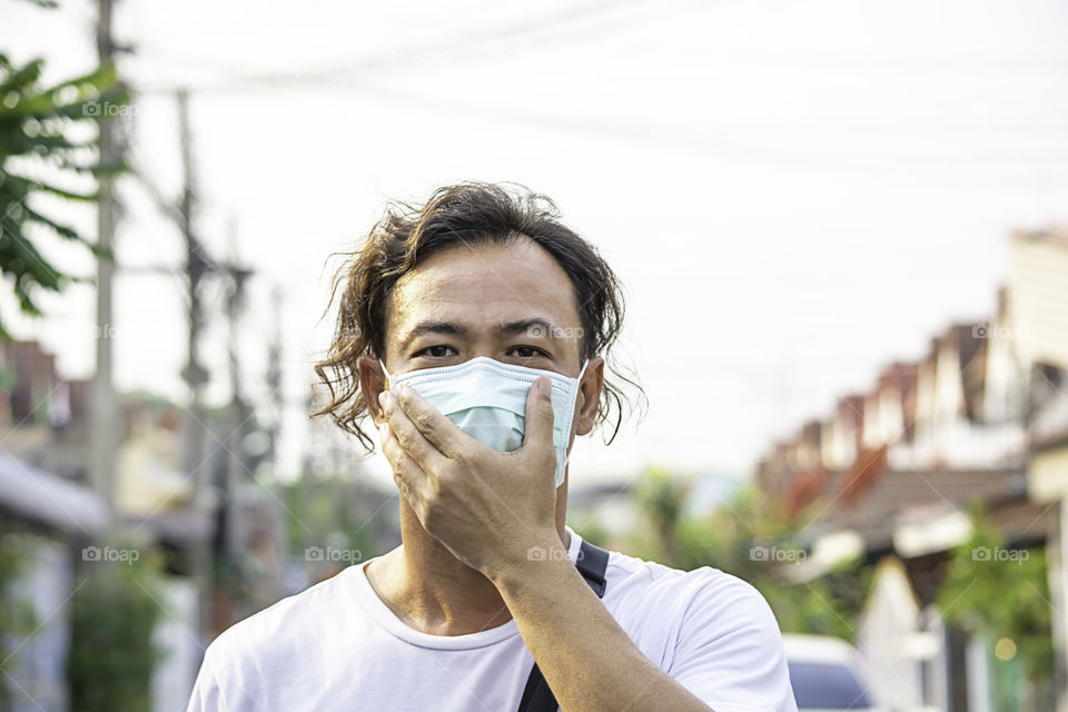 Asean man wear a mask to prevent dust in Bangkok ,Thailand