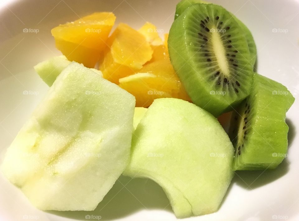 Fruit: apple, orange and kiwi.