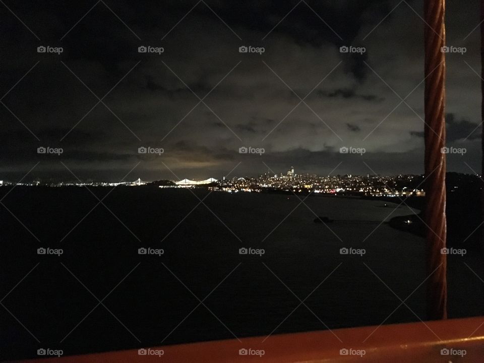 The city of San Francisco at night taken with the Golden Gate Bridge in the foreground 