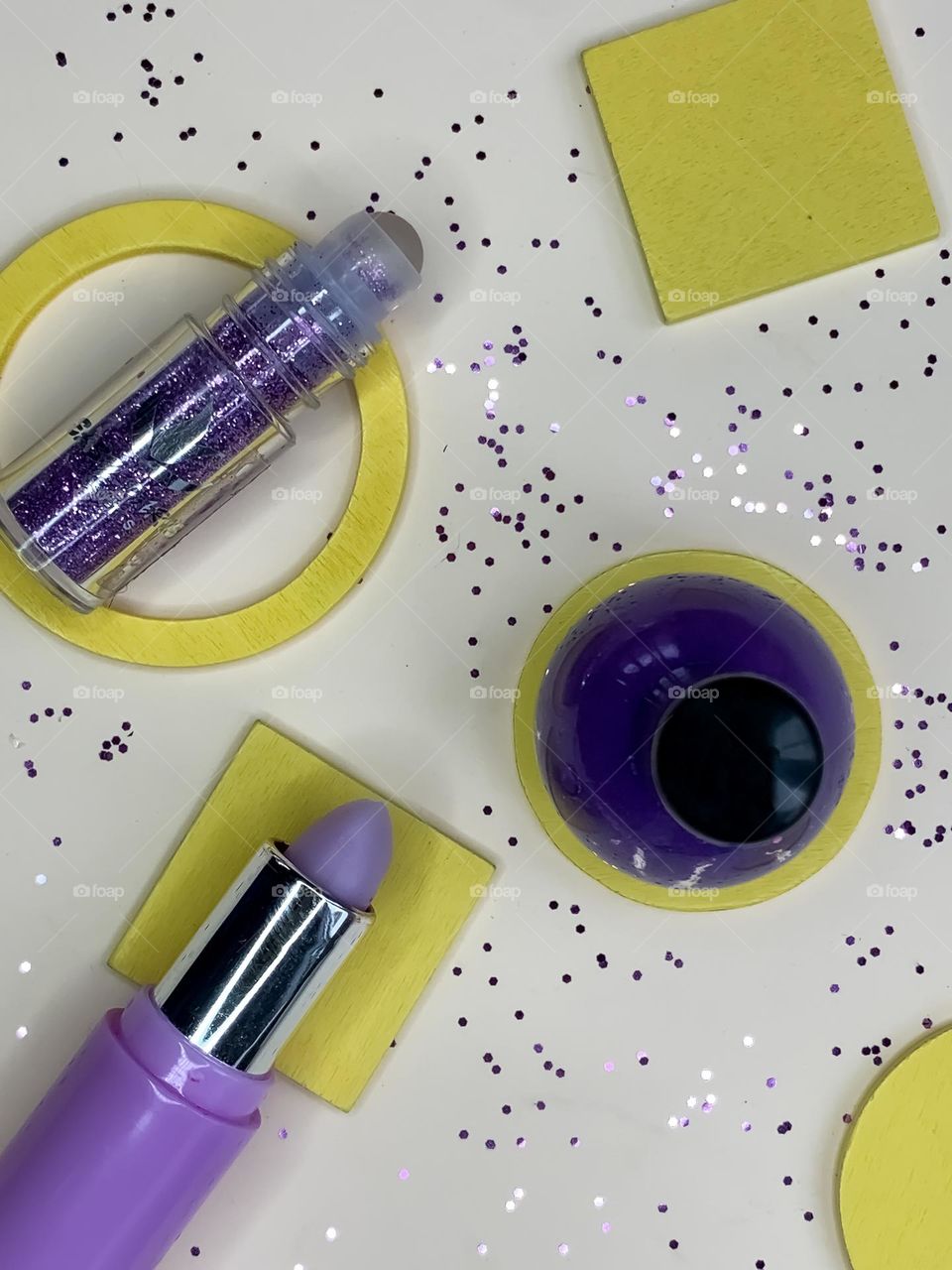 Purple & yellow cosmetics flat lay