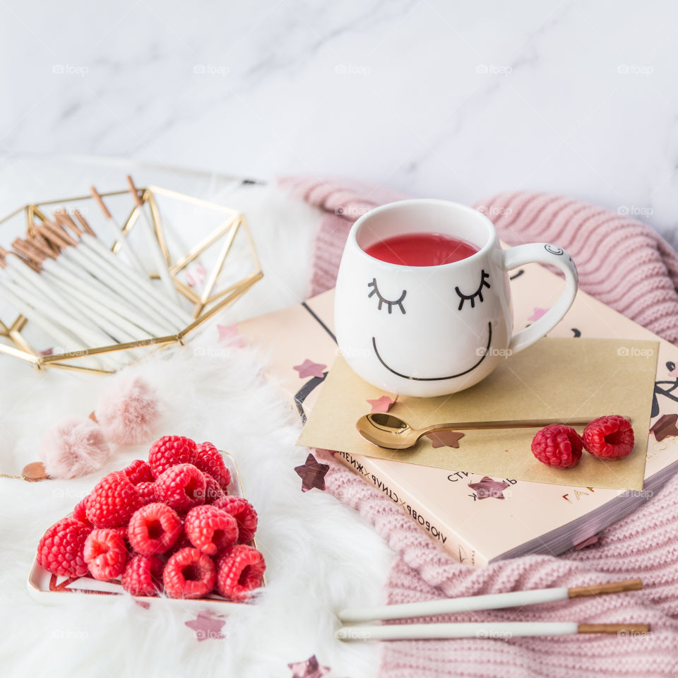 Composition with fresh raspberry and tea cup