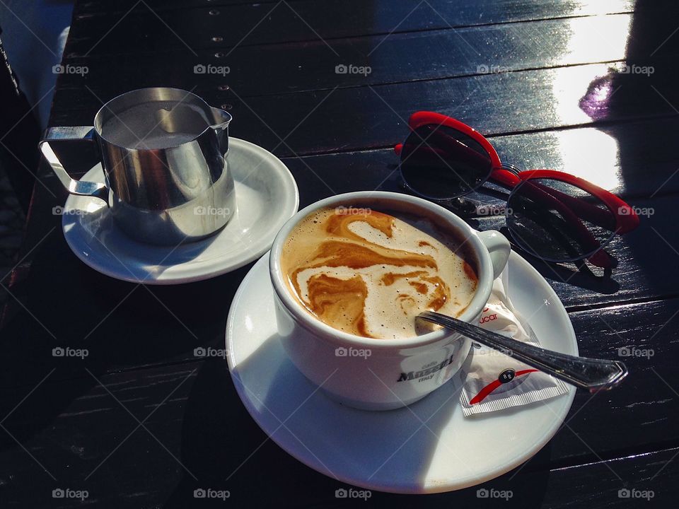 Cup of coffee with stylish sunglasses