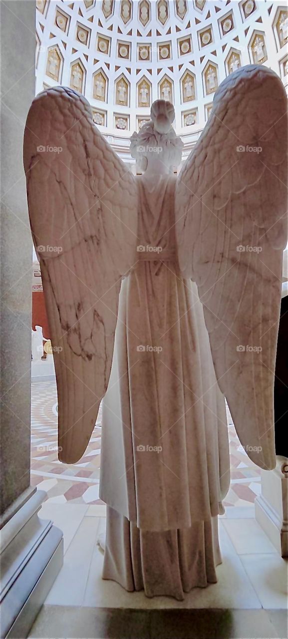 This is a large winged angel at “Liberation Hall” by “Kelheim”, Bavaria on the “Danube”. He joins fellow angels to form a huge circle around a mosaic floor with a central inscription commemorating the “Liberation Wars”. 2024. Hypnotic Productions