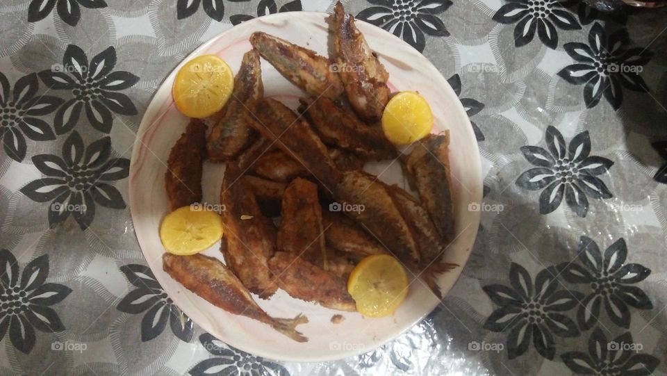 plate of fishes and lemon.