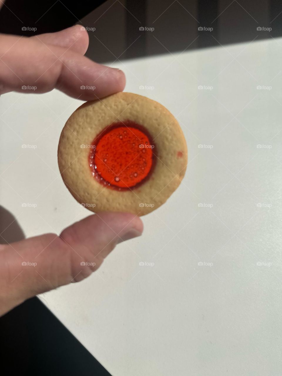 Man holds glass pane cookie, making holiday cookies, baking for fun, homemade cookies 