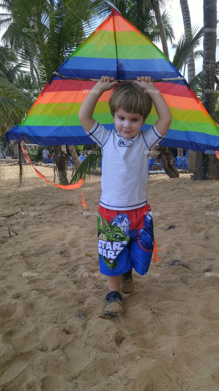 Boy playing with colorful kite