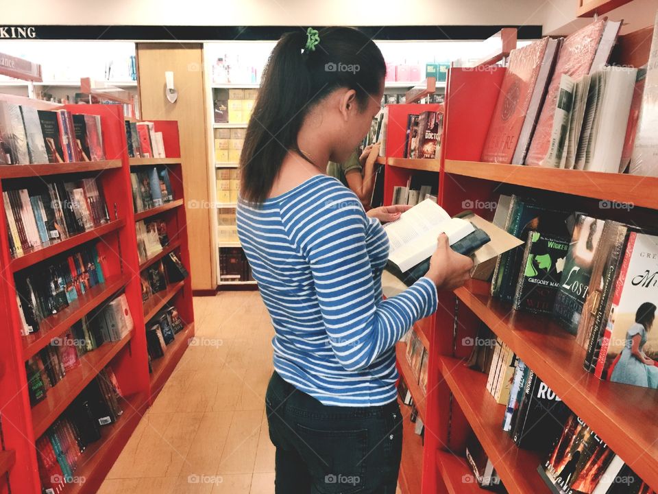 A woman reading at the library