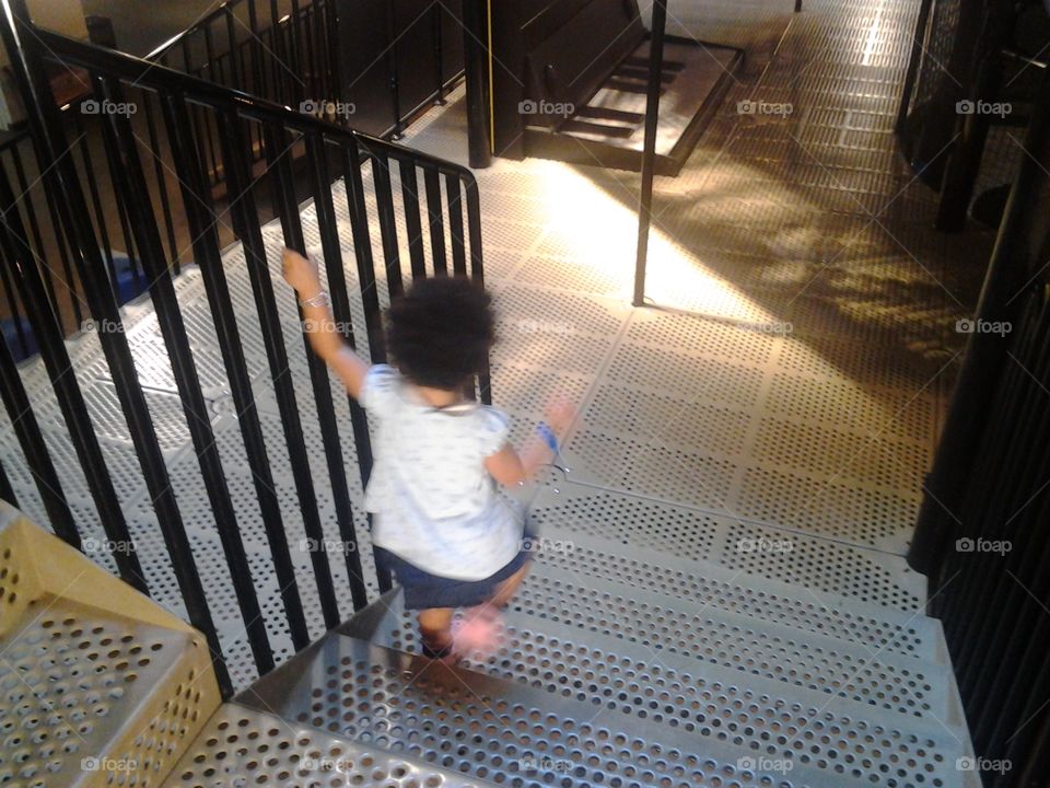 Excitement in Wonder. Carmen's first time going down the stairs of the Science Center by herself