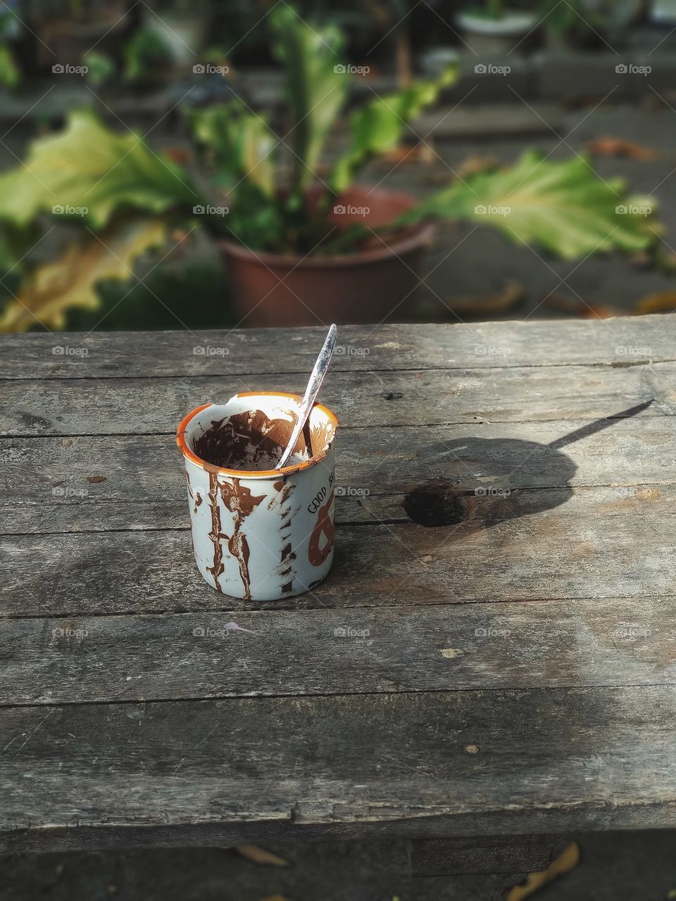 the empty glass on the wooden table