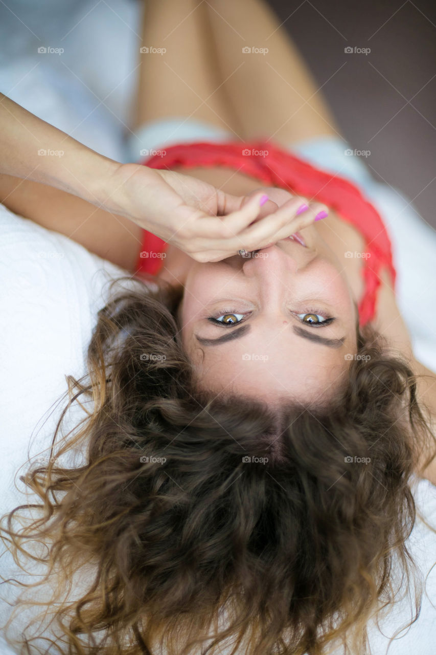 Close-up of woman lying on bed