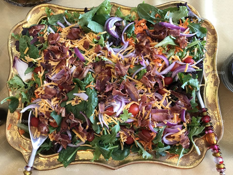 Huge Spinach salad on a platter 