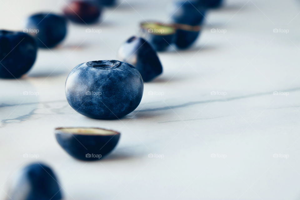 Flat lay fresh organic blueberries on a marble background 