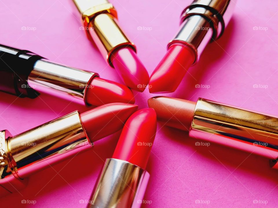 flat lay with colorful lipsticks in the foreground