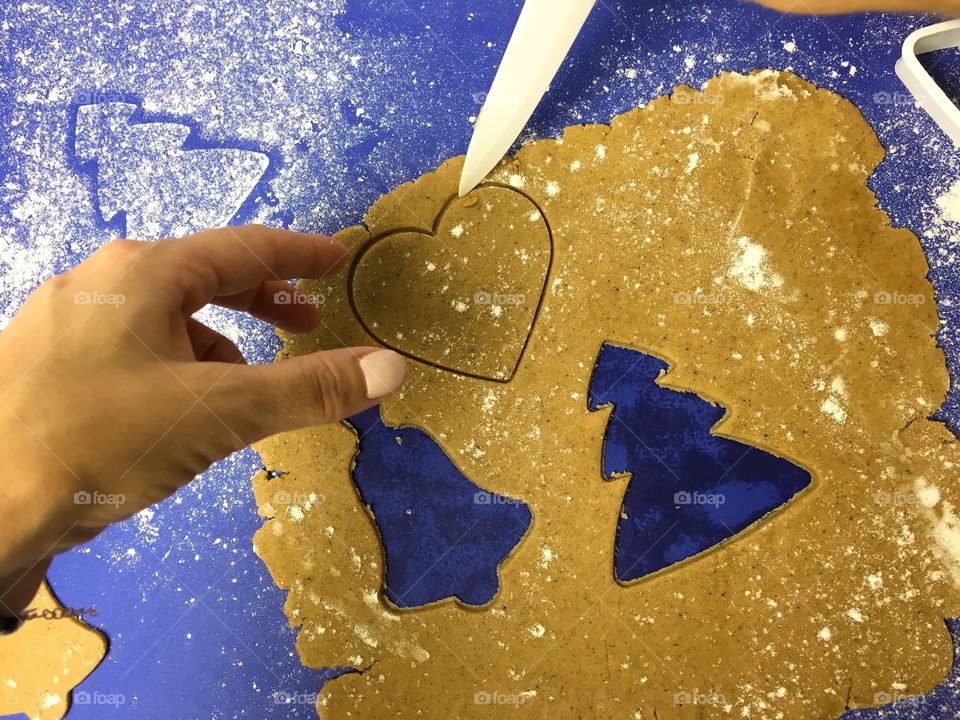 A person preparing gingerbread cookie