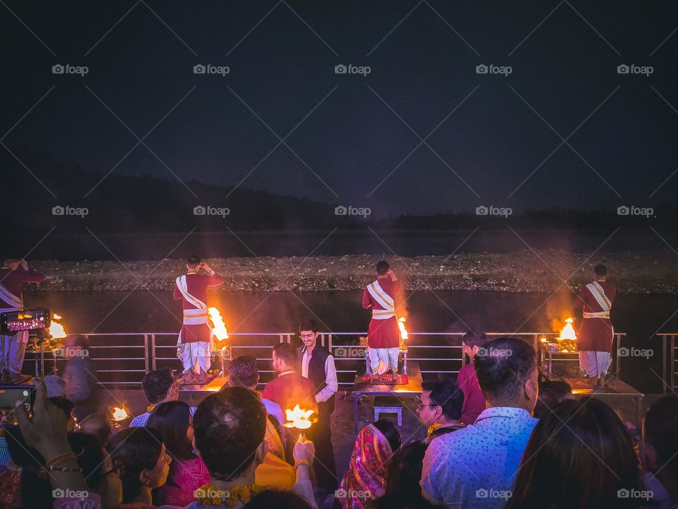 Priests performing ganga aarti at the banks of ganga river