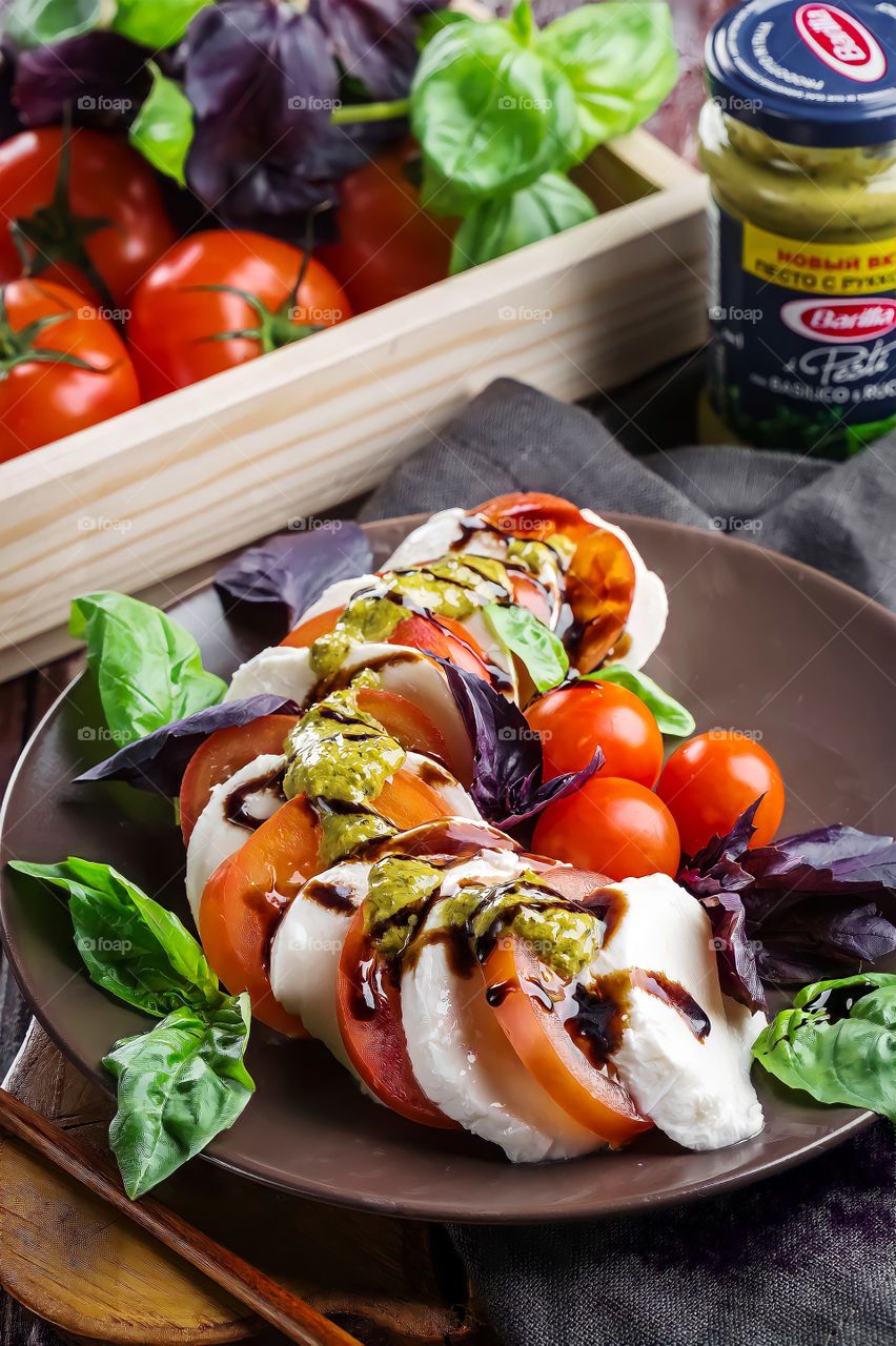 Close up of Caprese salad in brown ceramic plate