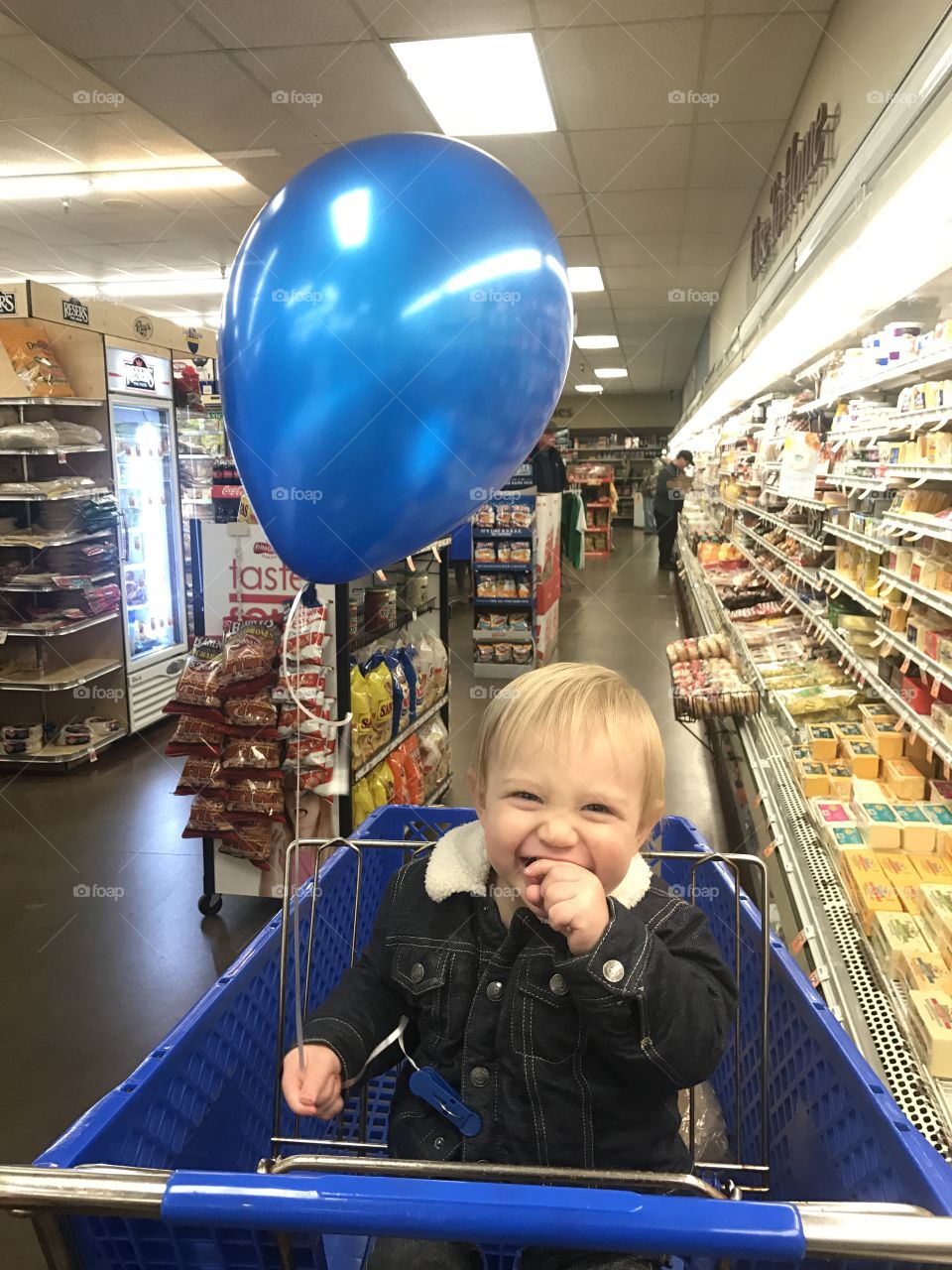 Happy boy sitting in trolley