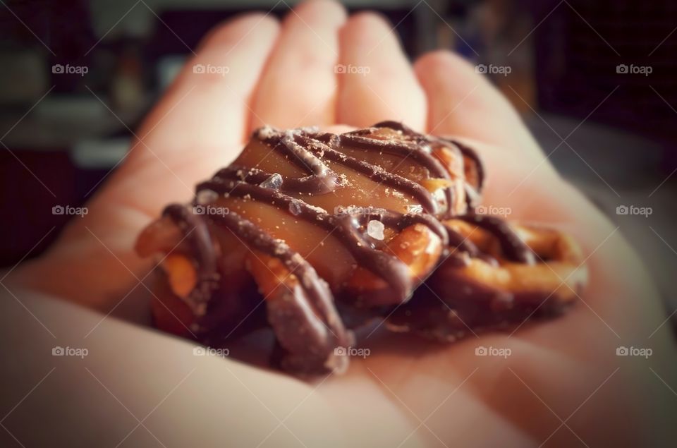 Chocolate Caramel Pretzels with Sea Salt in the Palm of a Hand